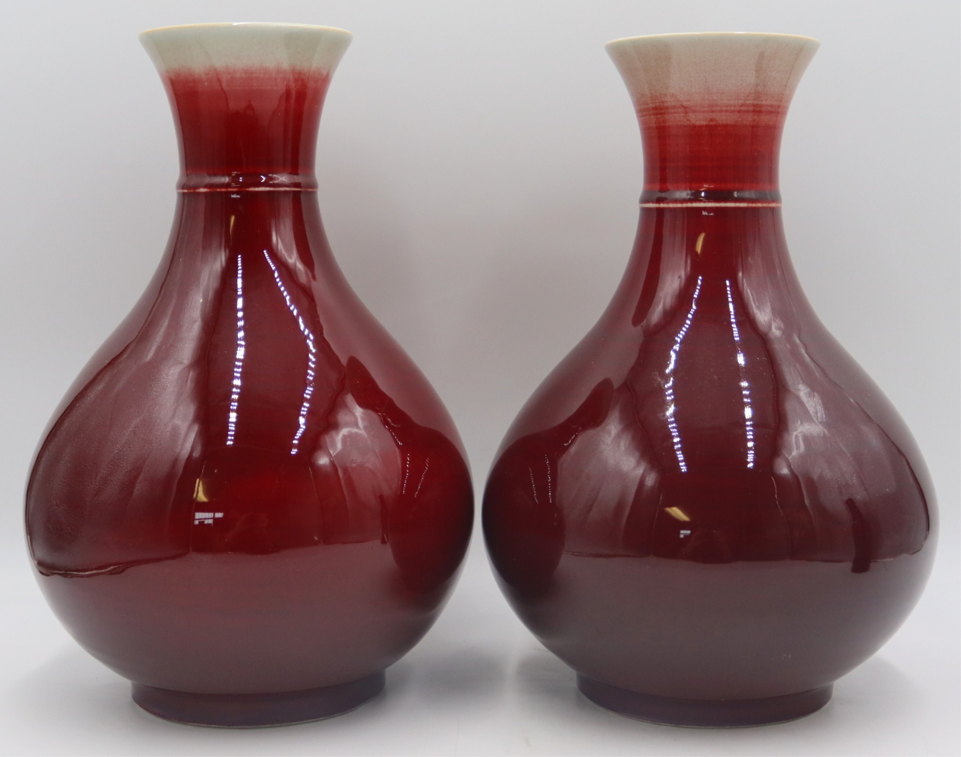 PAIR OF SIGNED SANG DE BEOUF VASES.