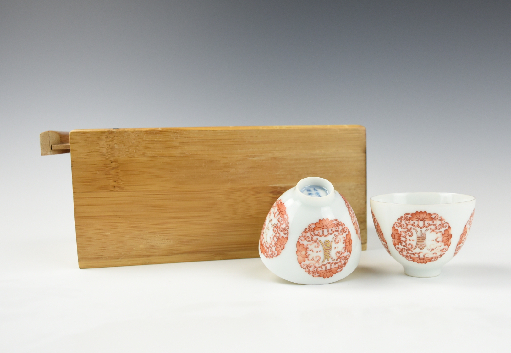PAIR OF SMALL CHINESE IRON RED CUPS