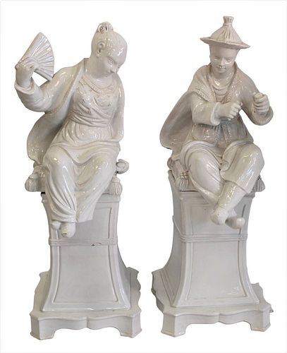 PAIR OF TERRACOTTA GLAZED SEATED