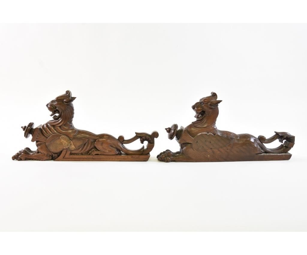 Pair of walnut carved recumbent