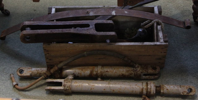 Parts from a fore-end loader for