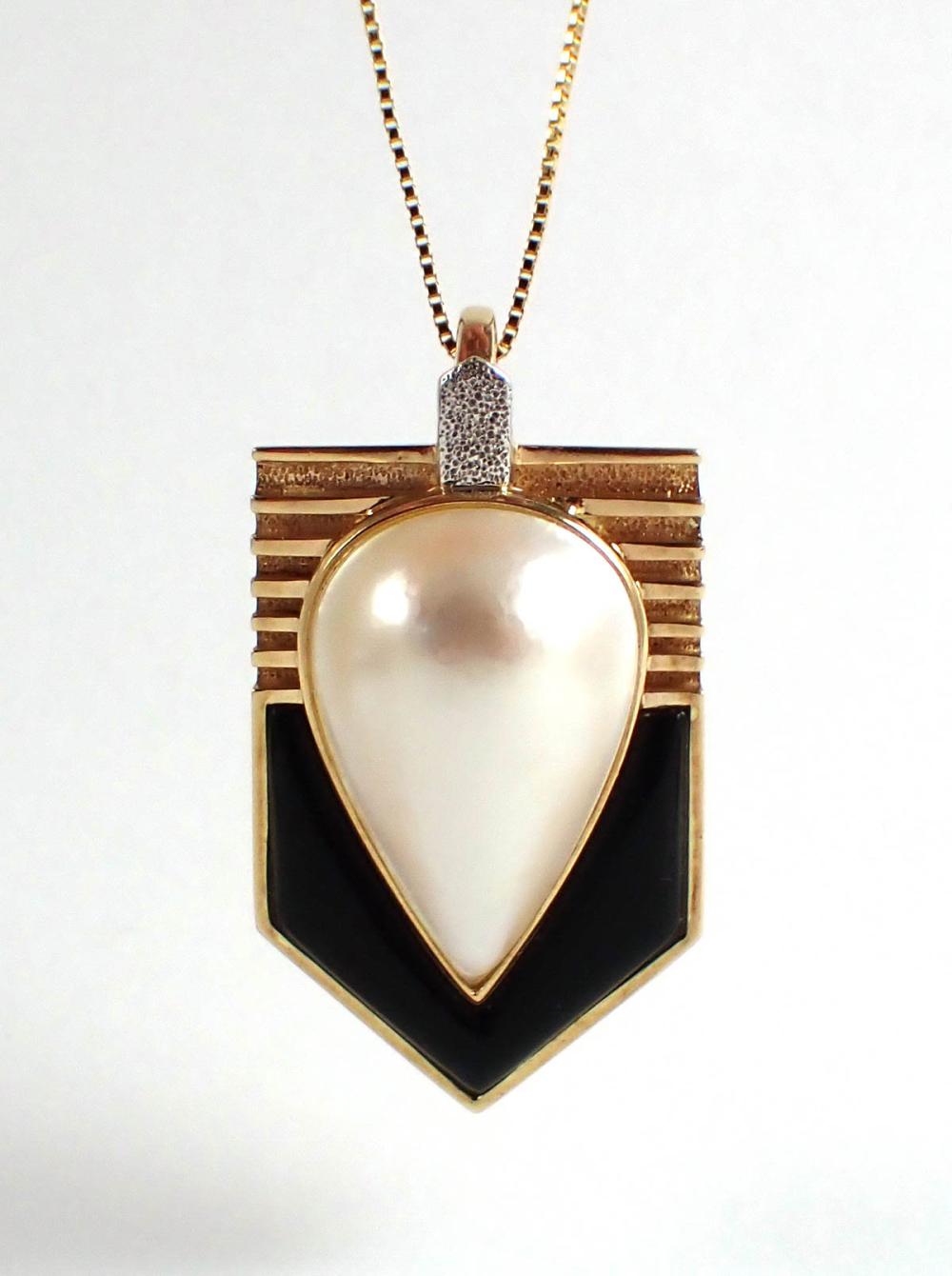 PEARL, ONYX AND FOURTEEN KARAT GOLD
