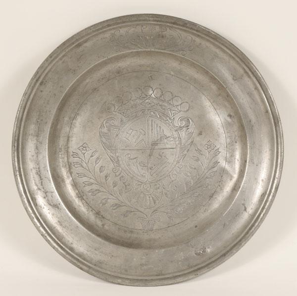 Pewter charger with crest; engraved