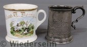 Pewter mug with a raised relie