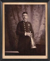 PHOTOGRAPH OF A FIREMAN HOLDIN