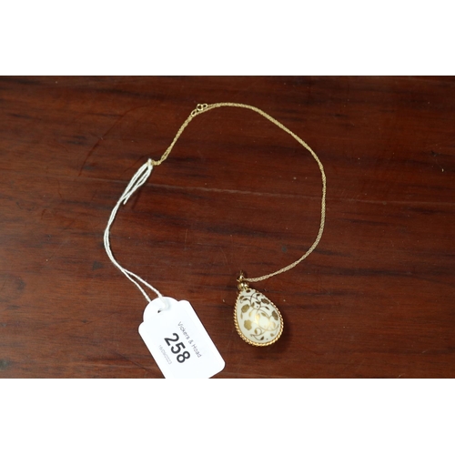 Porcelain gilt egg pendant on
