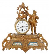 PORCELAIN-INSET GILT METAL FIG