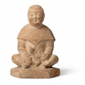 POTTERY FIGURE OF A BOY HOLDIN