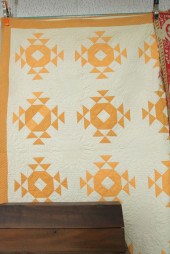 QUILT WITH ORANGE TRIANGLES. C
