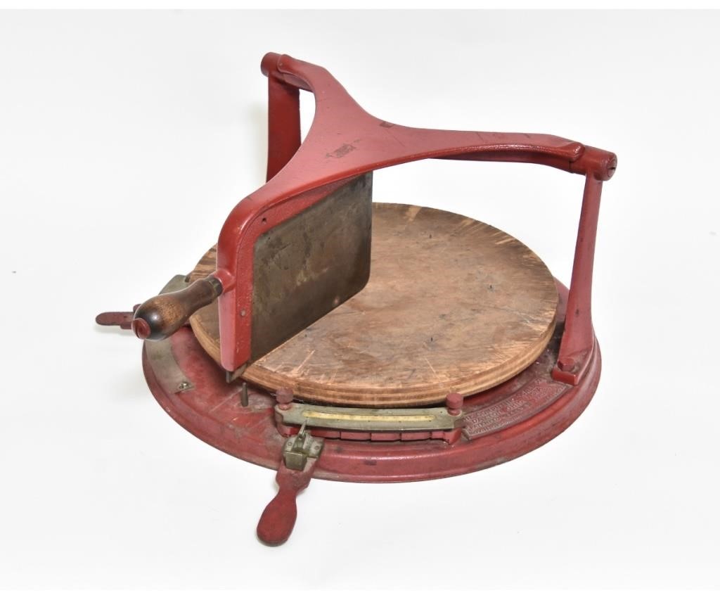Red metal cheese cutter marked 'The