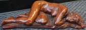 RED PLASTER FIGURE OF A RECLIN