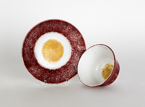 Red spatter cup and saucer with a