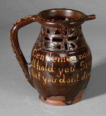 Redware puzzle jug, cutwork neck