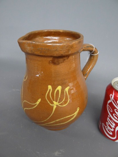 Redware slip decorated pitcher. 8''