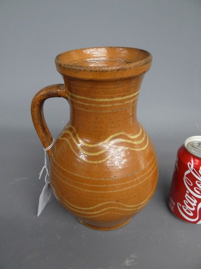 Redware slip decorated pitcher. 9