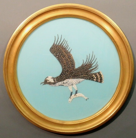 Round gilt framed shell work of a