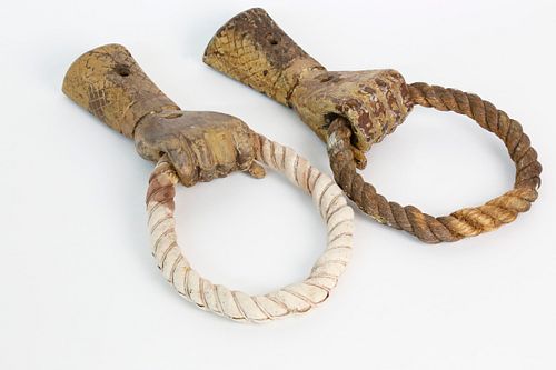 SCARCE PAIR OF FIST CARVED BECKETS,