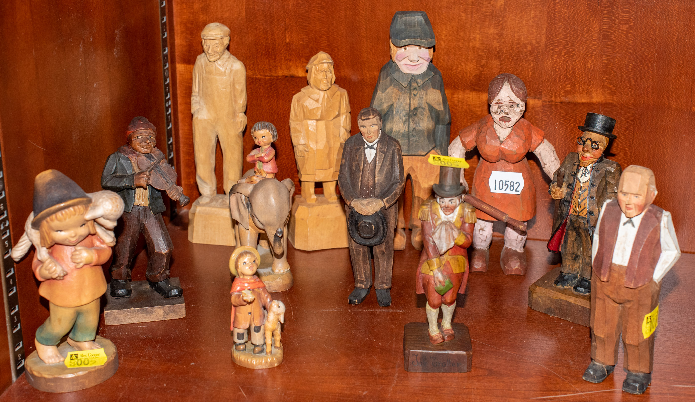 SELECTION OF 12 CARVED WOODEN