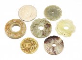 SEVEN ASIAN CARVED STONE DISKS