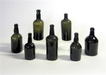 Seven blown  green glass liquor