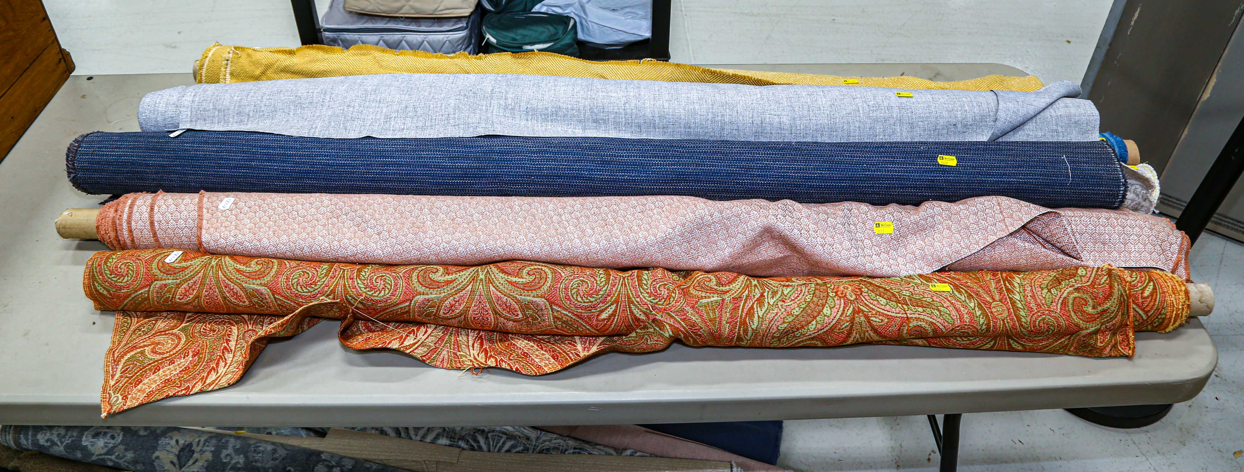 SEVEN BOLTS OF UPHOLSTERY FABRIC .