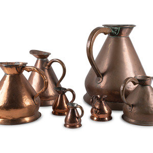 Seven Copper Graduated Pitchers