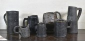 SEVEN EARLY LEATHER TANKARDS A