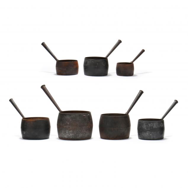 SEVEN GRADUATED ANTIQUE IRON