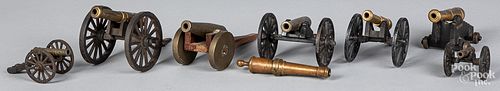 SEVEN IRON AND BRASS TOY CANNONS,