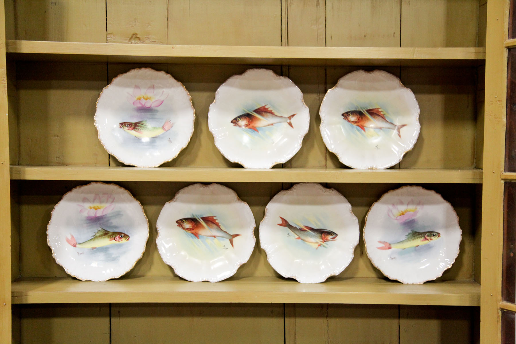 SEVEN LIMOGES FISH PLATES.  France