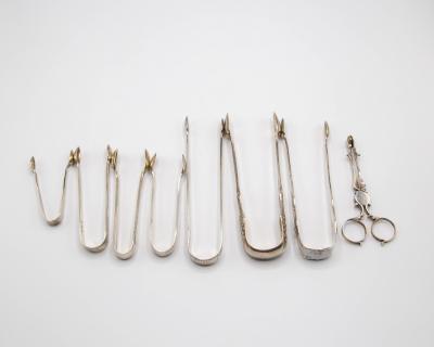 Seven pairs of silver sugar nips