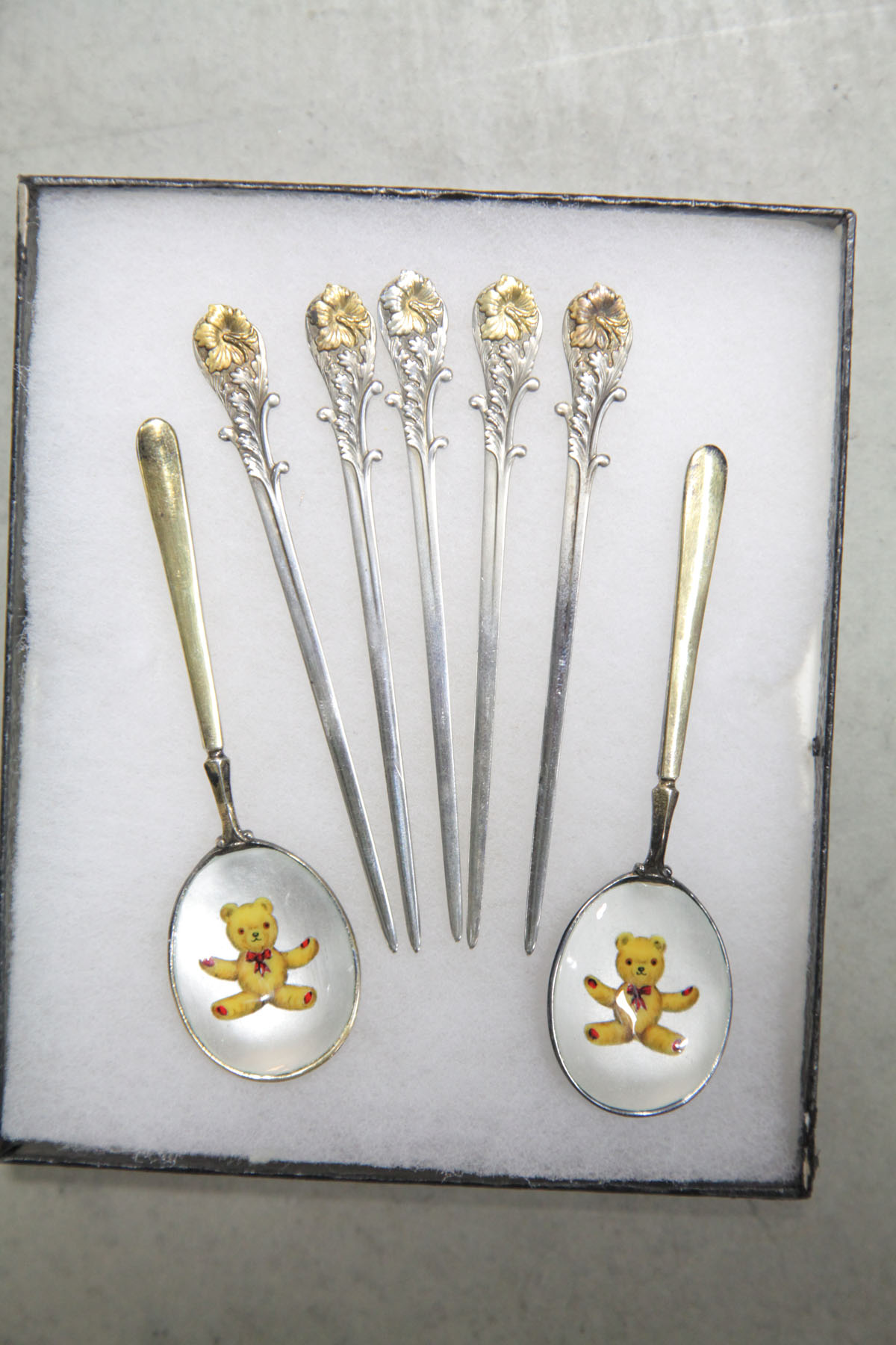 SEVEN PIECES.  Five silver picks