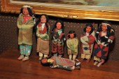 SEVEN SKOOKUM DOLLS. 9'' h. to