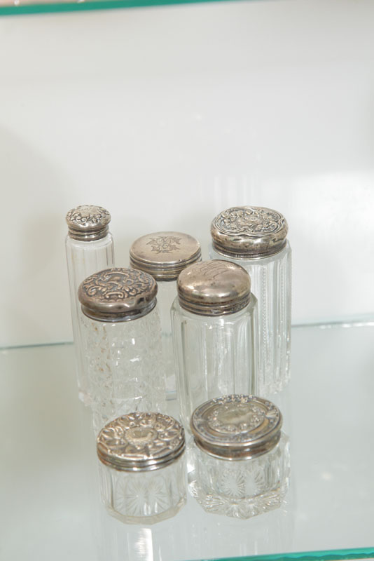 SEVEN SMALL DRESSER JARS WITH