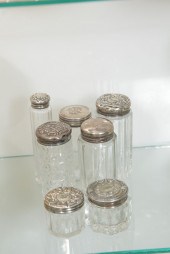 SEVEN SMALL DRESSER JARS WITH