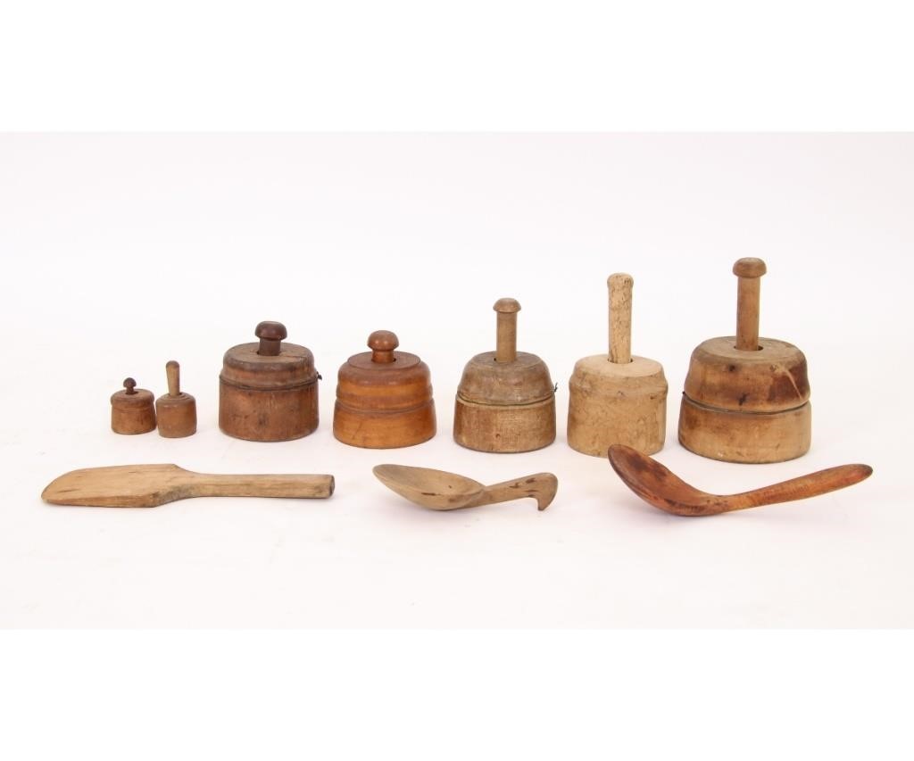 Seven wooden butter pats;