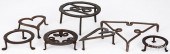 SEVEN WROUGHT IRON TRIVETS, 19