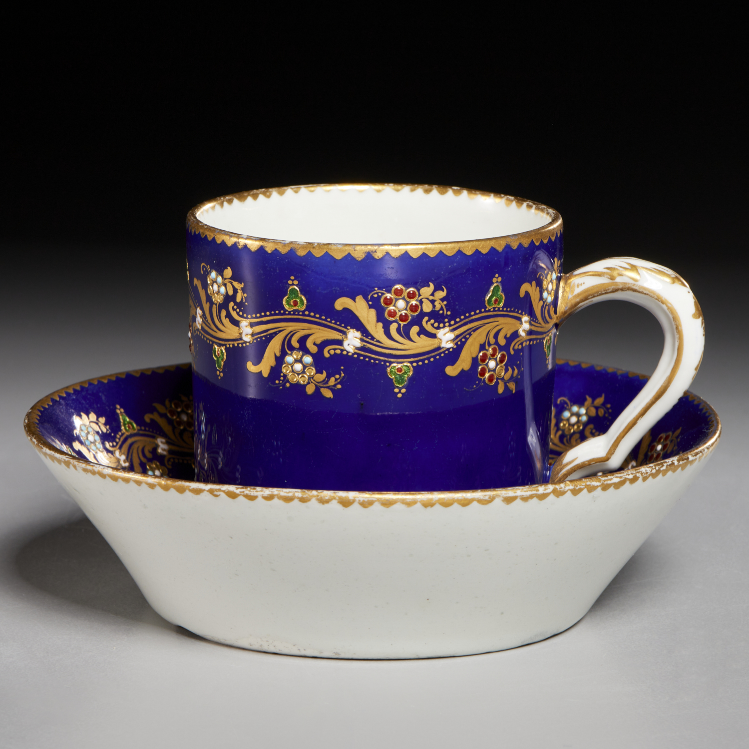 SEVRES JEWELED COBALT TEACUP AND