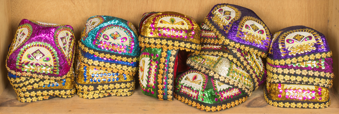 SHELF OF ASIAN EMBROIDERED HATS