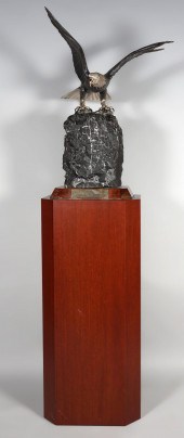 SILVERED METAL EAGLE ON ROCK,