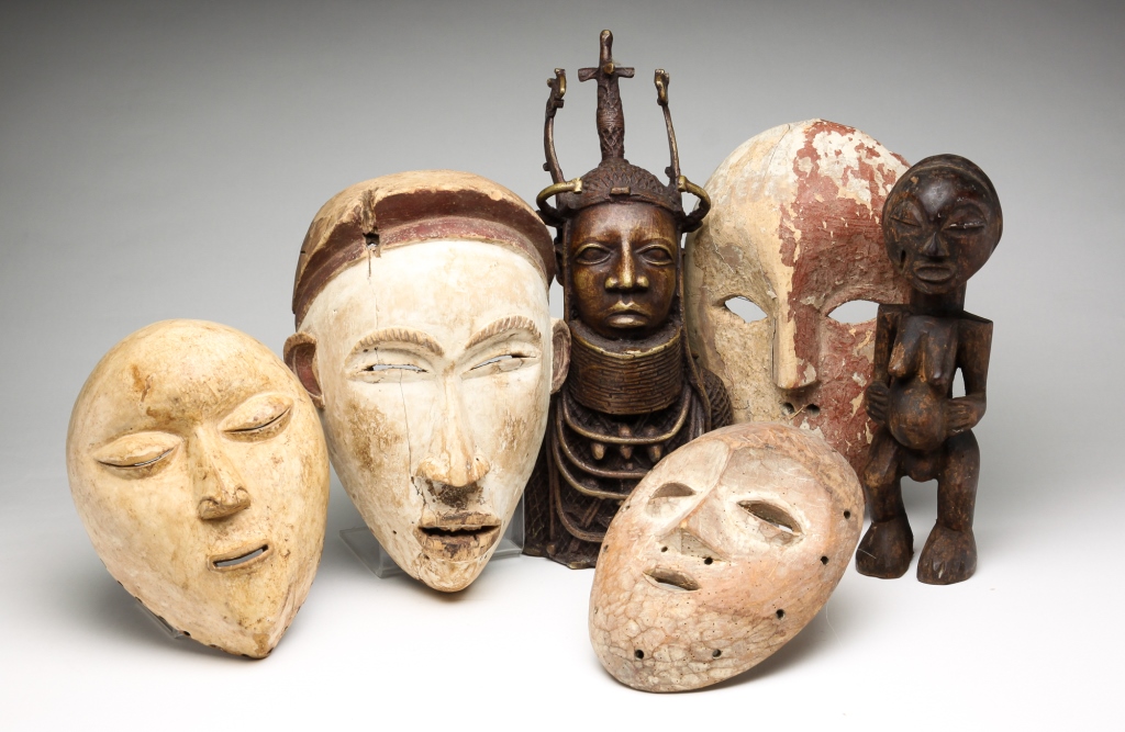 SIX AFRICAN MASKS AND STATUES.