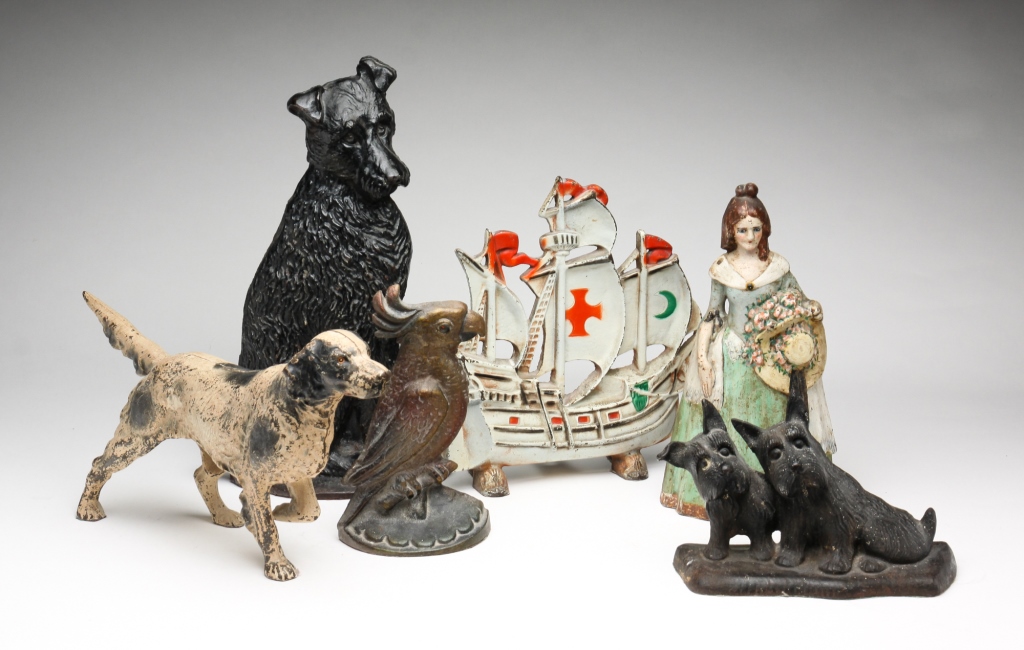 SIX CAST IRON DOORSTOPS. American