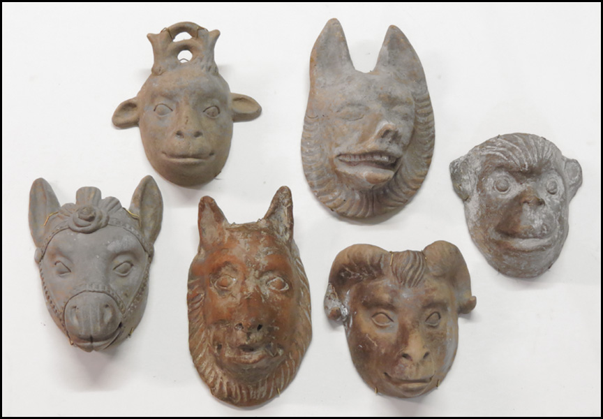 SIX CLAY MASKS. Comprised of two