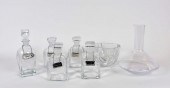 SIX COLORLESS GLASS DECANTERS