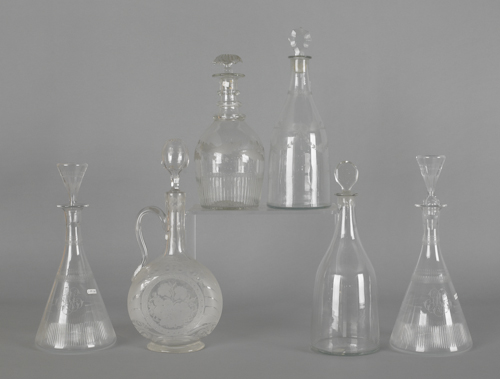Six colorless glass decanters