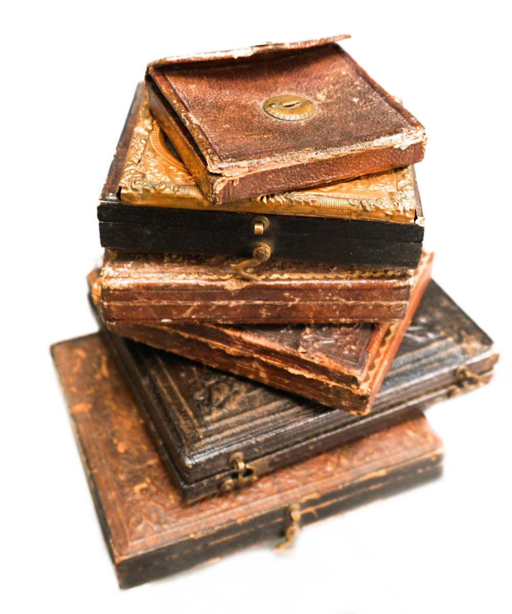 SIX EMBOSSED LEATHER ENCASED