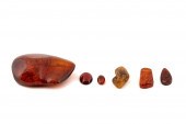 SIX LOOSE AMBER GEMSTONES, SOM