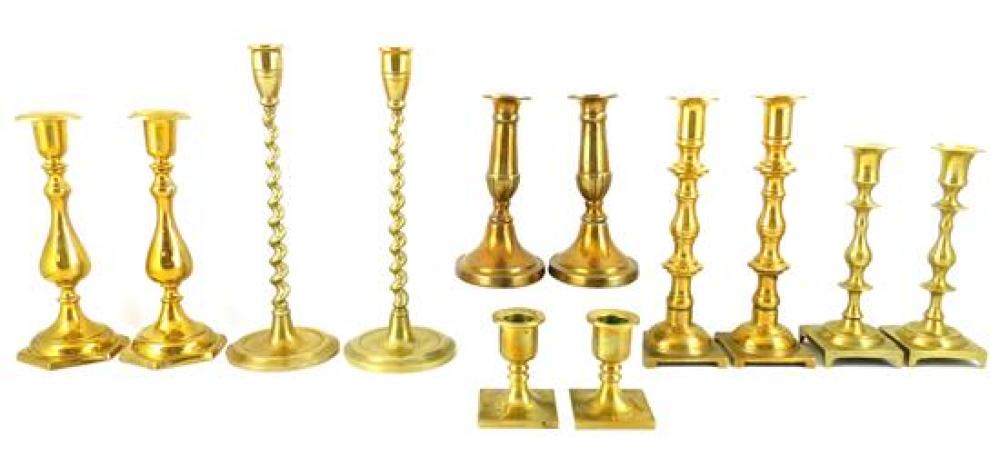 SIX PAIRS OF BRASS CANDLESTICKS,