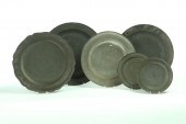 SIX PEWTER PLATES AND CHARGERS