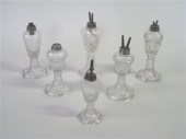 Six pressed uncolored glass fl